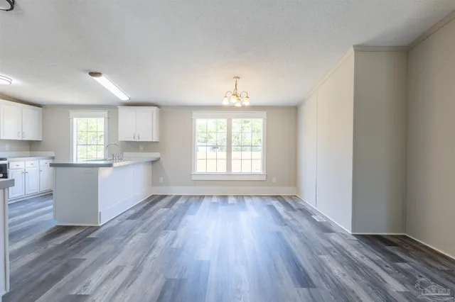 a view of a kitchen and wooden floor