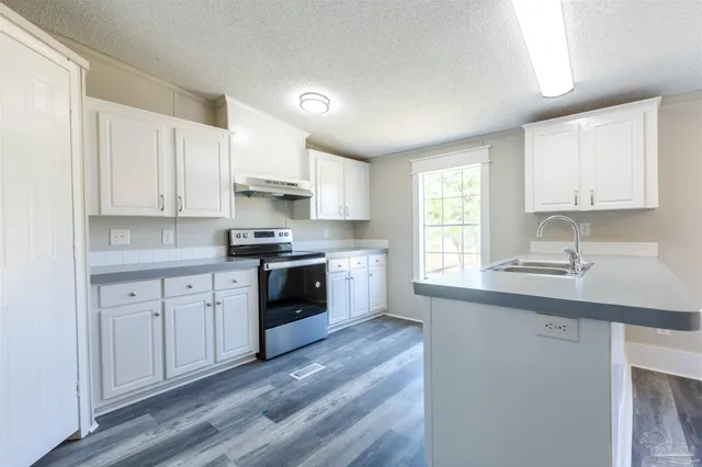 a kitchen with granite countertop white cabinets and white appliances
