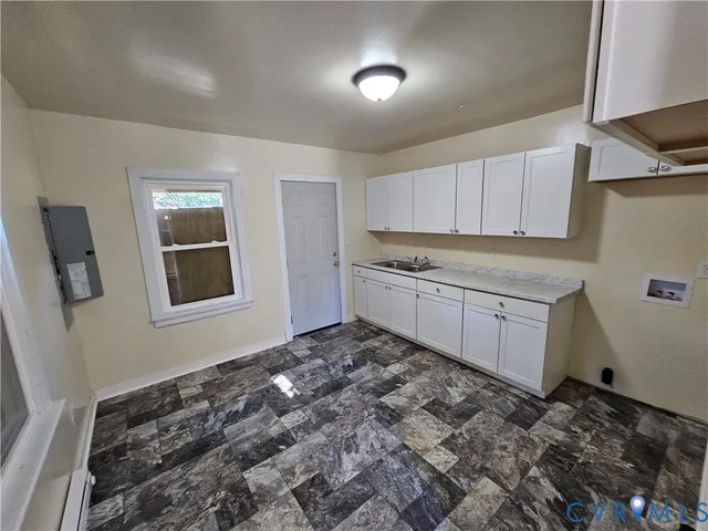 a kitchen with a stove top oven sink and cabinets