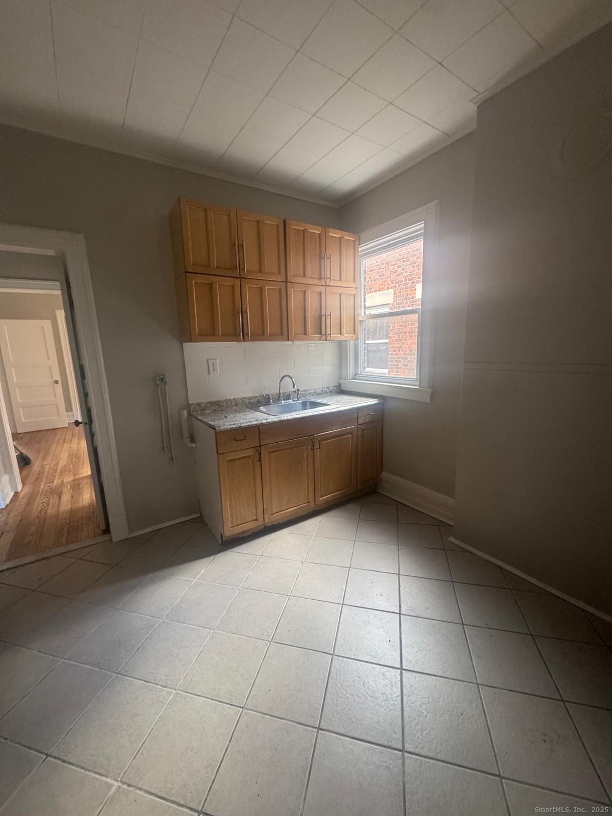 287 Dover Street, Unit 2 Bridgeport, CT 06610 - Photo 2 of 6 a view of kitchen and window