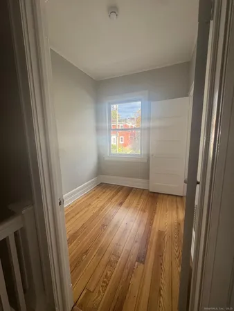 a view of an empty room and wooden floor