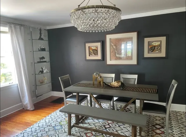 a view of a dining room with furniture and wooden floor