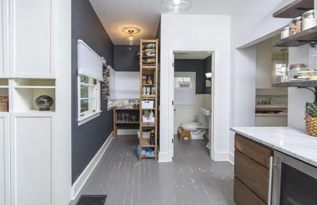 a view of living room with furniture and wooden floor