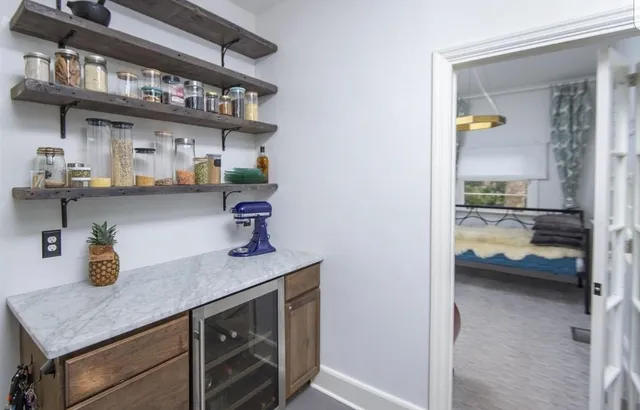 a kitchen with stainless steel appliances granite countertop a sink and wooden cabinets