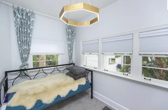 a bedroom with a bed and a large window