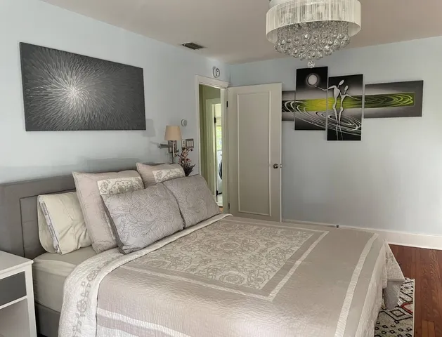 a bedroom with a bed and a chandelier