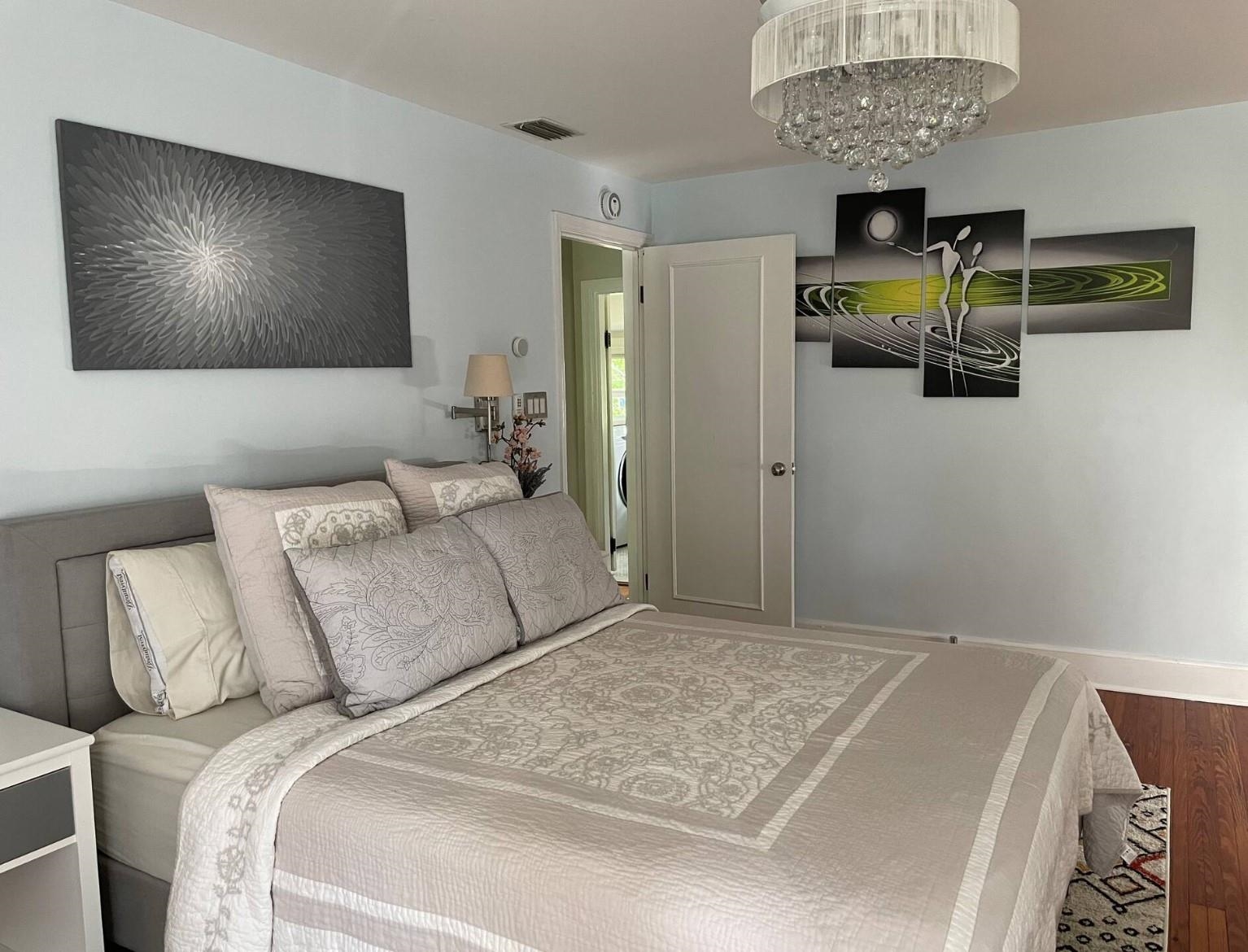8 Tremerton Street St. Augustine, FL 32084 - Photo 23 of 41 a bedroom with a bed and a chandelier