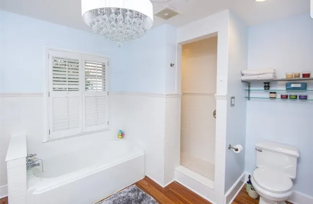 a white bath tub sitting next to a white toilet