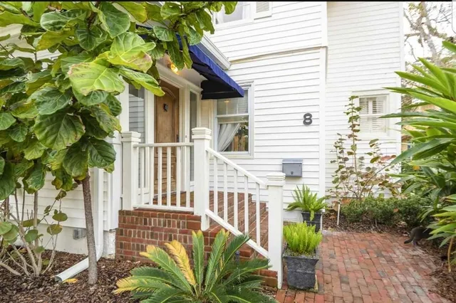 a view of a house with a flower garden