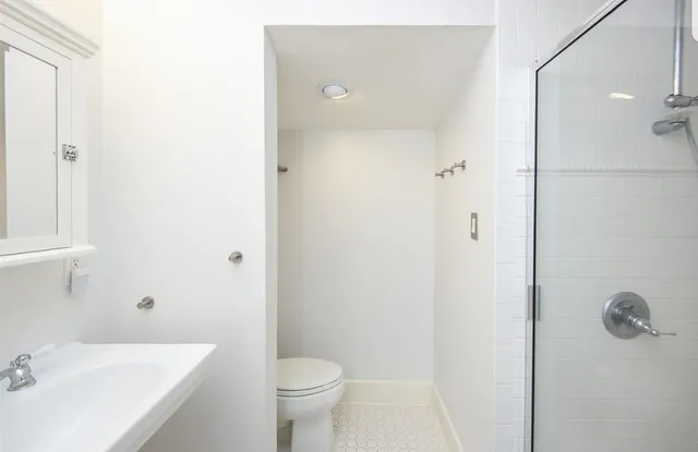 a bathroom with a sink toilet and shower