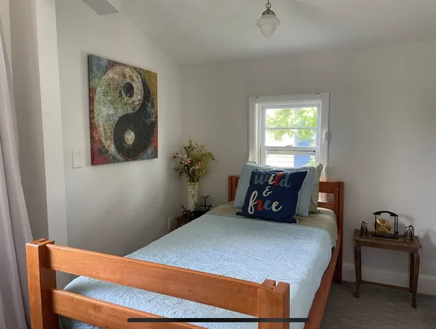 a bedroom with a bed and window