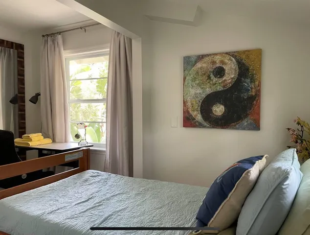 a bedroom with a bed and window