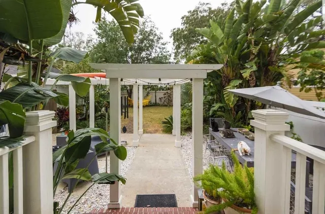 a view of a patio with table and chairs potted plants