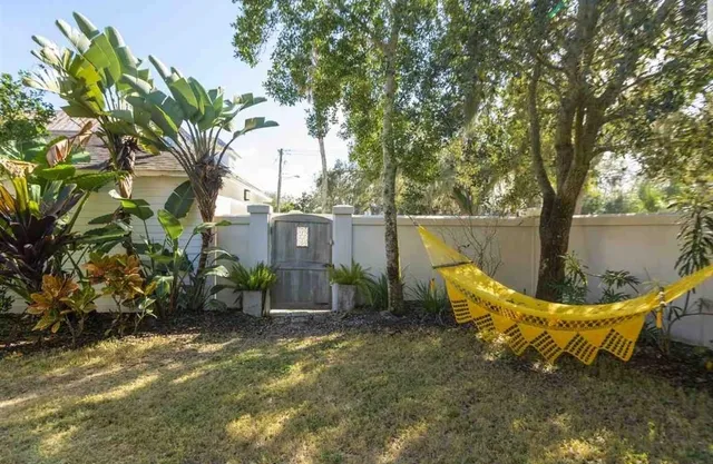 a view of a chair and table in the backyard
