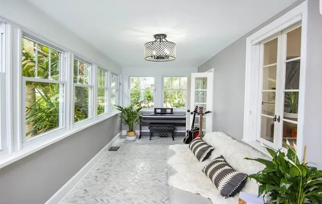 a bedroom with furniture and a window