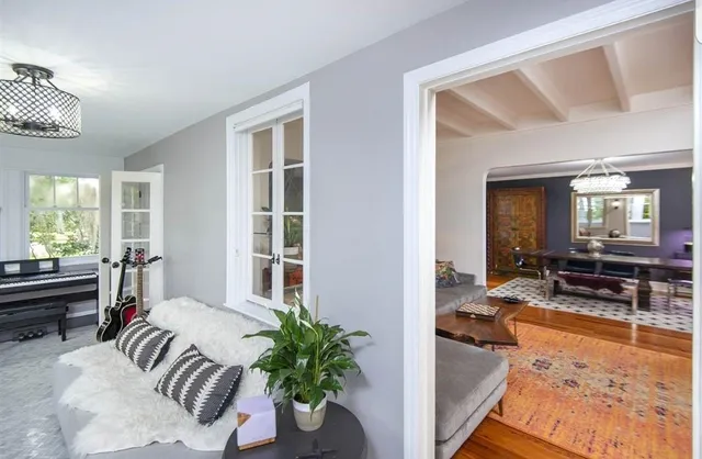 a bedroom with furniture and a large window