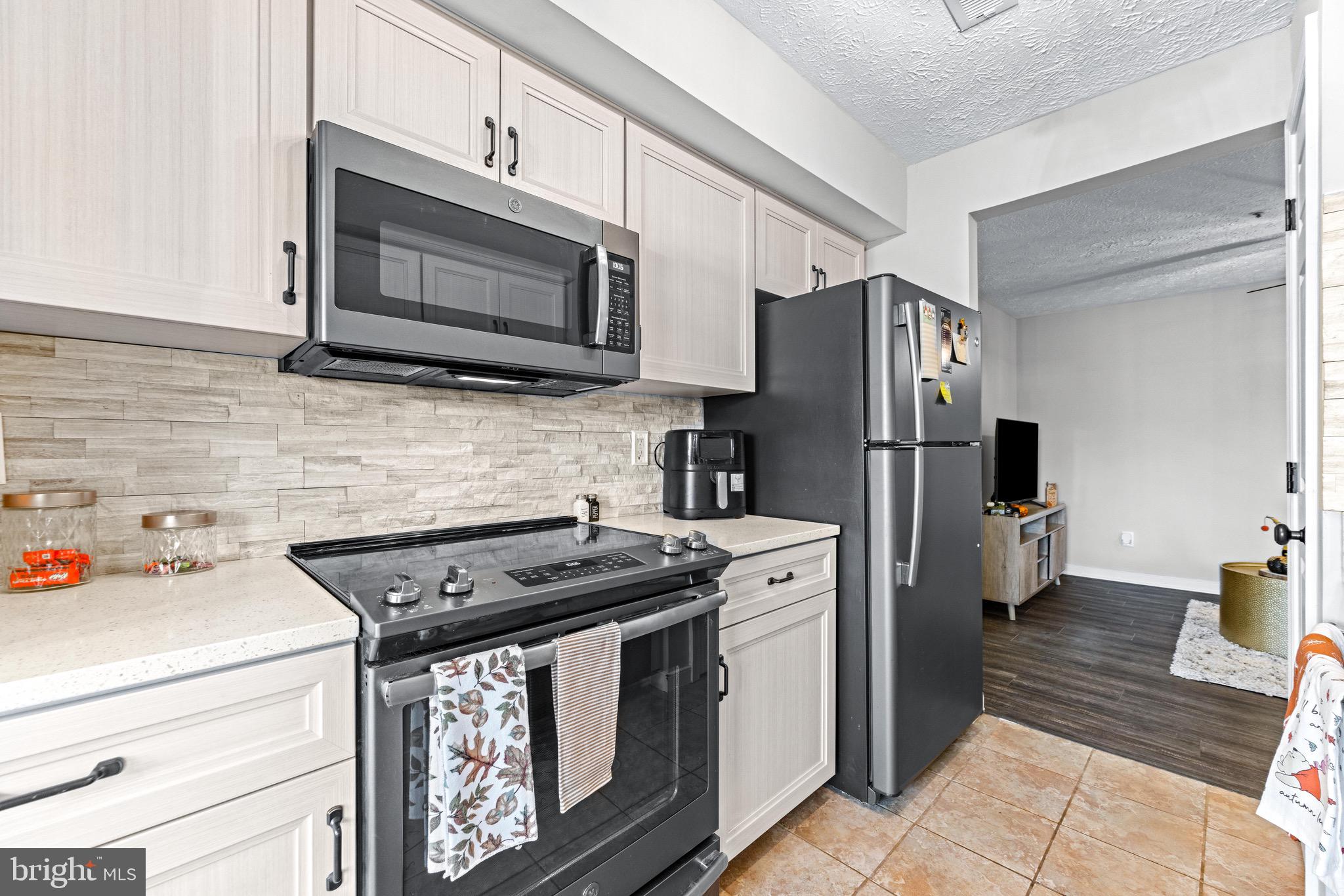 1713 Landmark Drive, Unit 1L Forest Hill, MD 21050 - Photo 11 of 28 a kitchen with stainless steel appliances a stove microwave and refrigerator