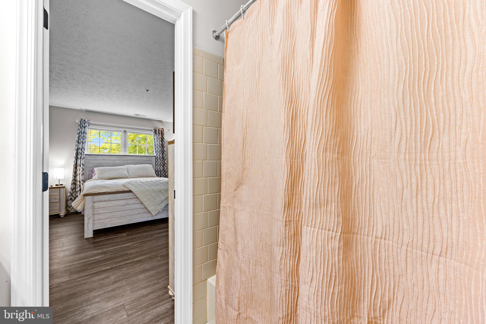 1713 Landmark Drive, Unit 1L Forest Hill, MD 21050 - Photo 19 of 28 a walk in closet with a large window and a wooden floor