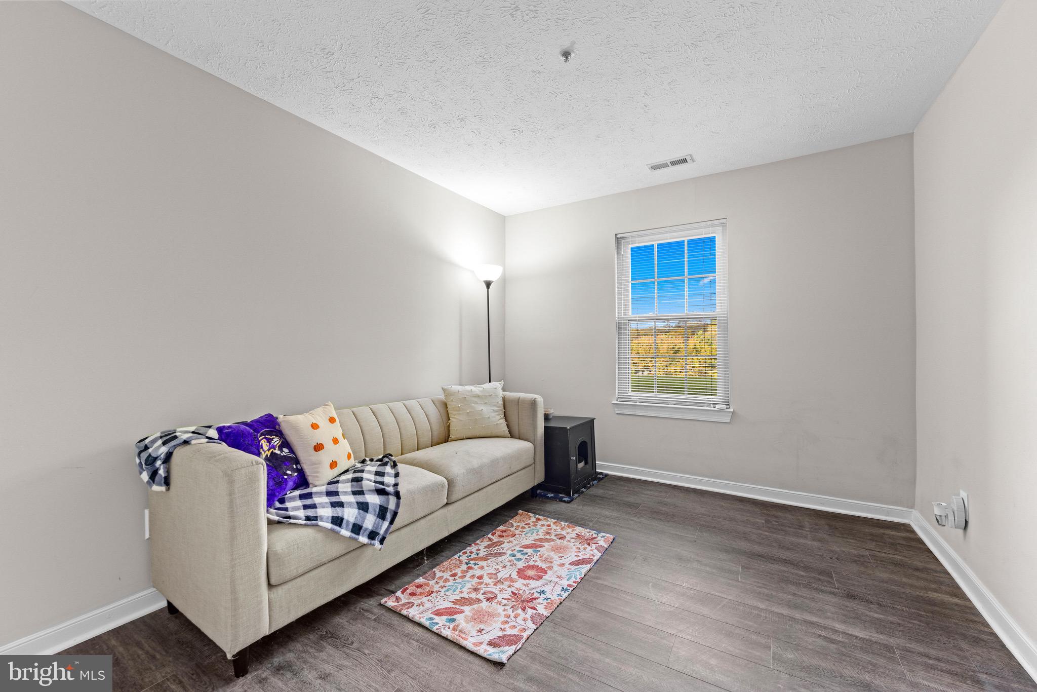 1713 Landmark Drive, Unit 1L Forest Hill, MD 21050 - Photo 20 of 28 a living room with furniture and a rug