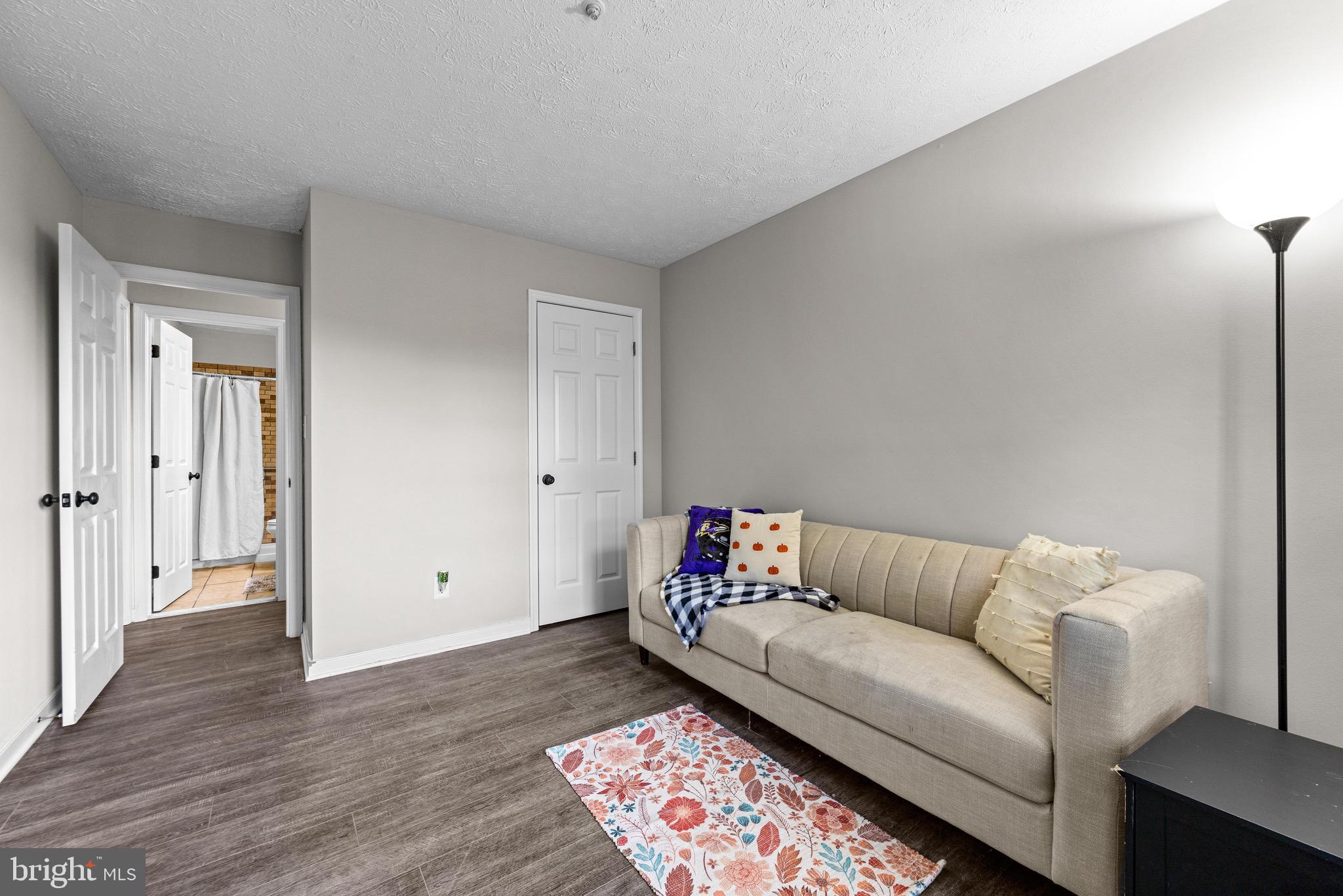 1713 Landmark Drive, Unit 1L Forest Hill, MD 21050 - Photo 21 of 28 a living room with furniture and wooden floor