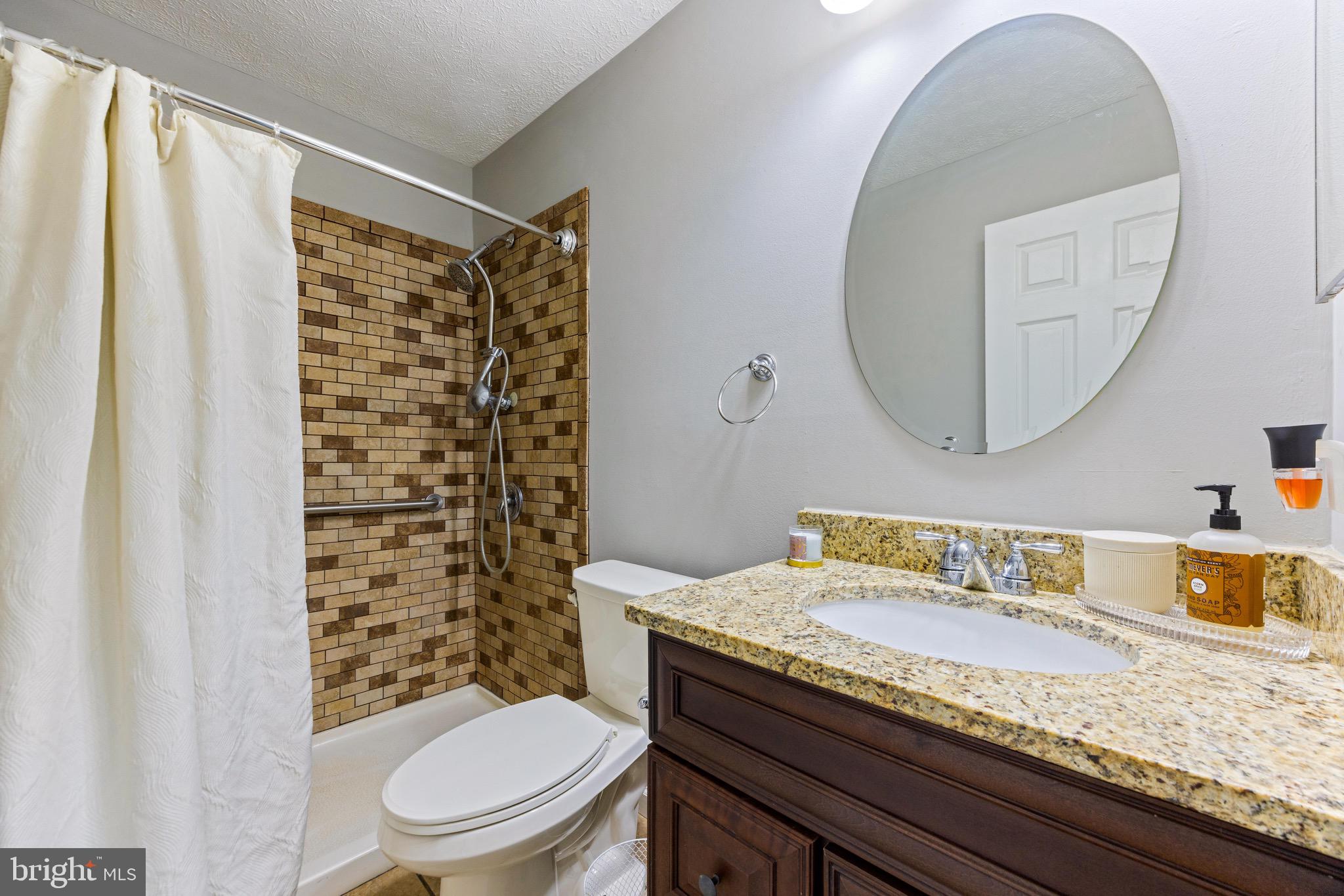 1713 Landmark Drive, Unit 1L Forest Hill, MD 21050 - Photo 22 of 28 a bathroom with a granite countertop sink toilet and shower