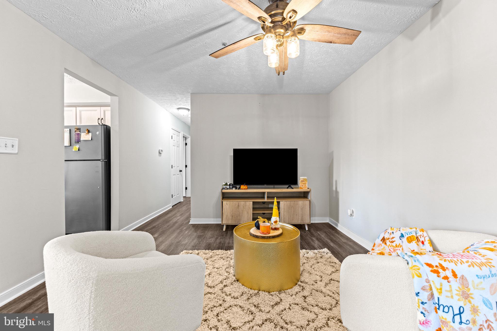 1713 Landmark Drive, Unit 1L Forest Hill, MD 21050 - Photo 5 of 28 a living room with furniture and a flat screen tv