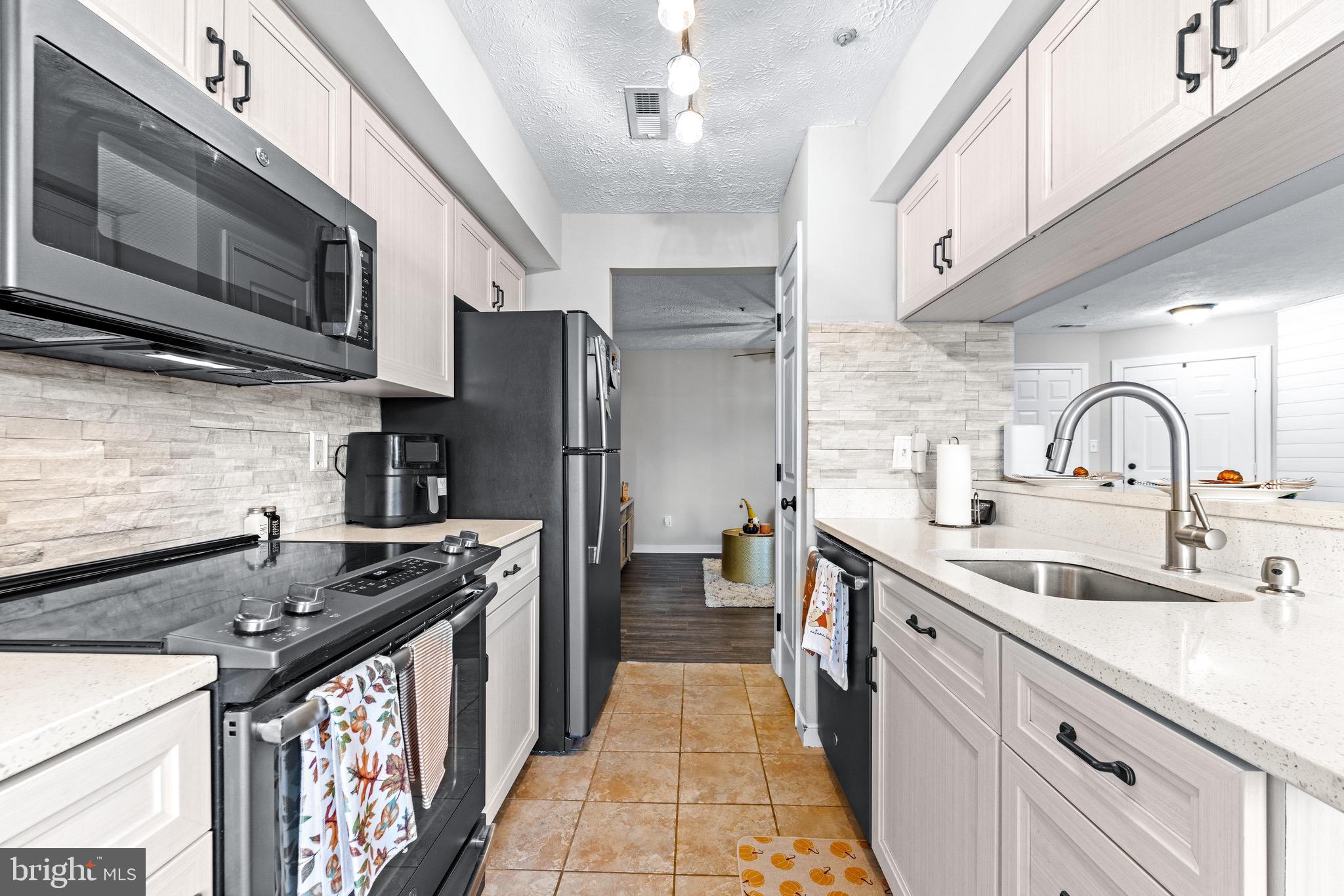 1713 Landmark Drive, Unit 1L Forest Hill, MD 21050 - Photo 10 of 28 a kitchen with stainless steel appliances a sink stove and refrigerator