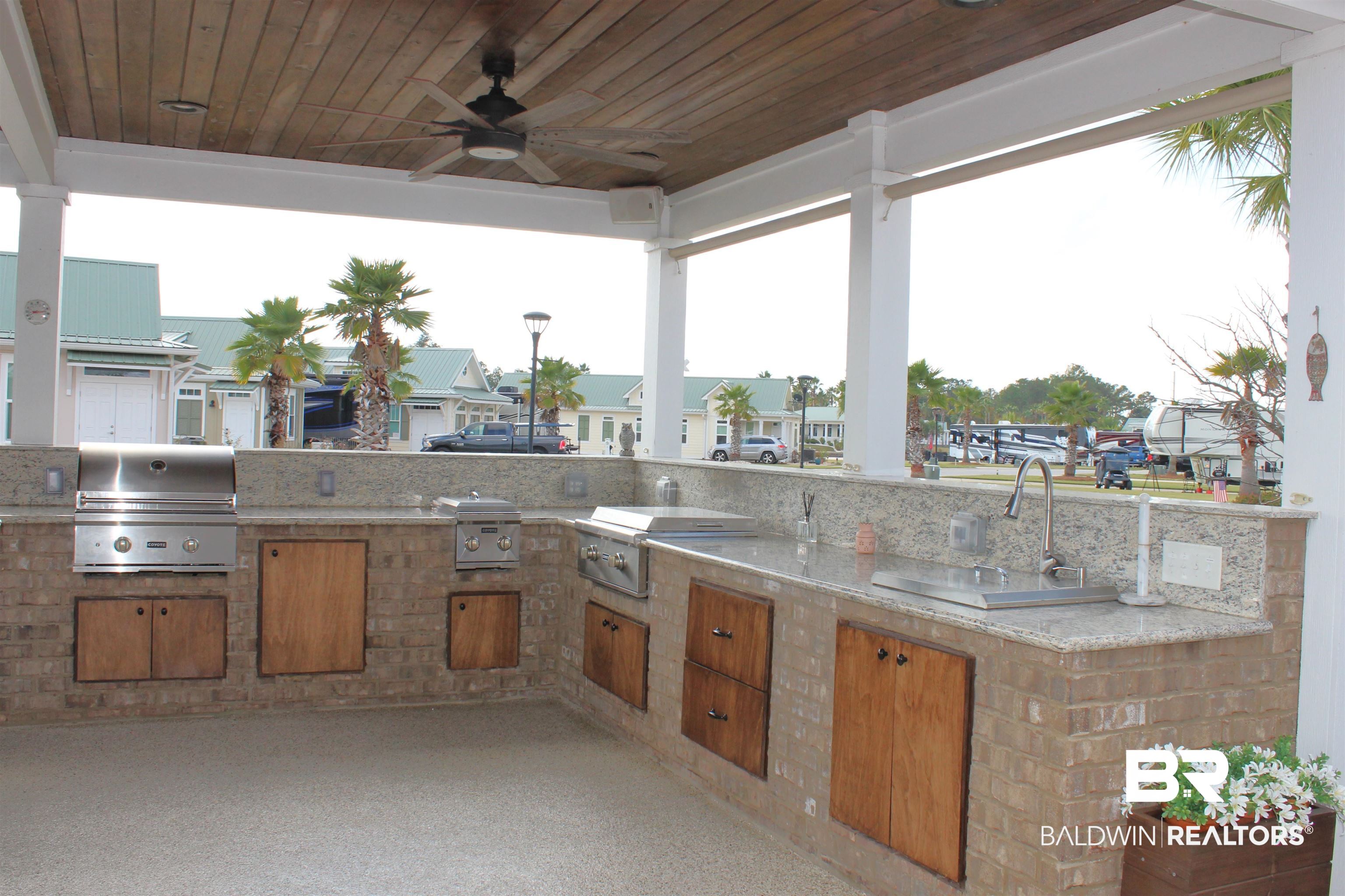 28238 Migratory Way Elberta, AL 36530 - Photo 15 of 58 View of patio featuring area for grilling, ceiling fan, and a residential view