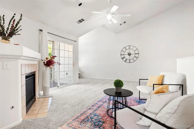 a living room with furniture a fireplace and a chandelier