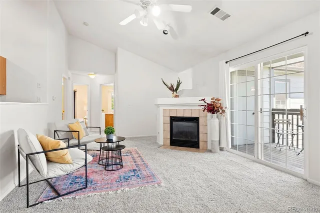 a living room with furniture a fireplace and a flat screen tv