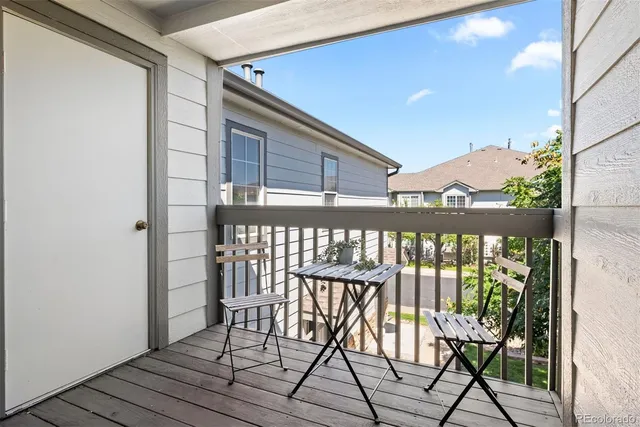 a balcony view with a seating space