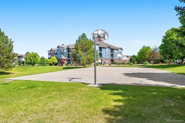 a sign board with tall buildings in the background