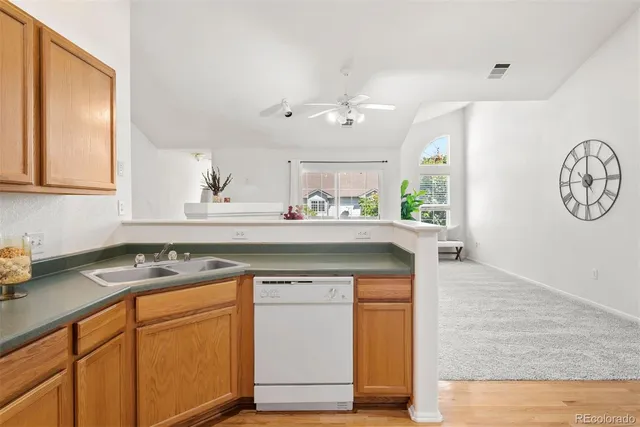 a kitchen with a sink cabinets and a window