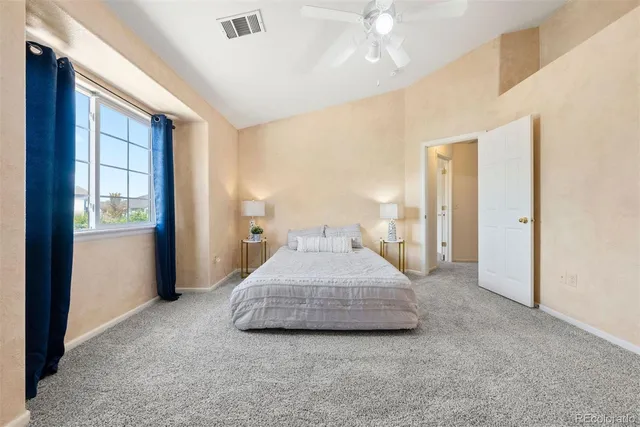 a spacious bedroom with a bed and closet