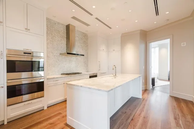 a kitchen with a sink and a stove top oven