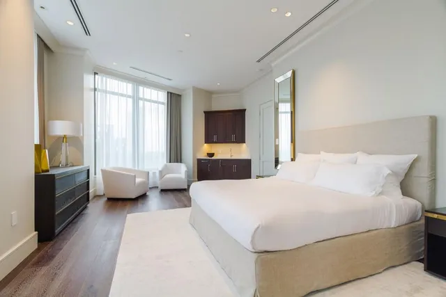 a bedroom with a large bed and a couch