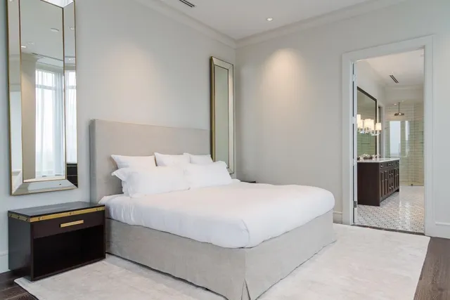 a bedroom with a bed and a lamp