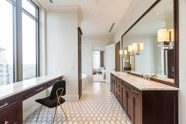 a spacious bathroom with a double vanity sink a mirror and a bathtub