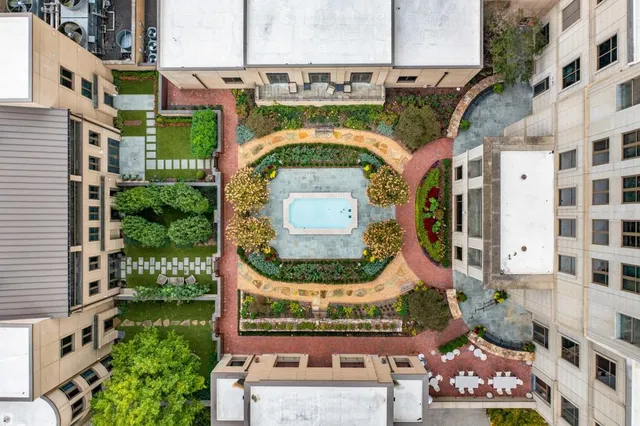 an aerial view of a residential houses with yard and outdoor seating