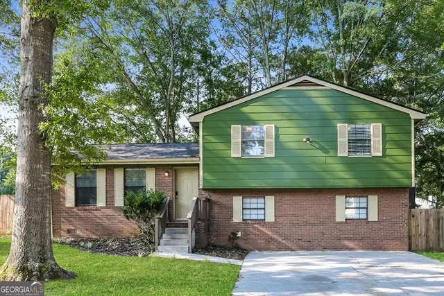 a front view of a house with garden