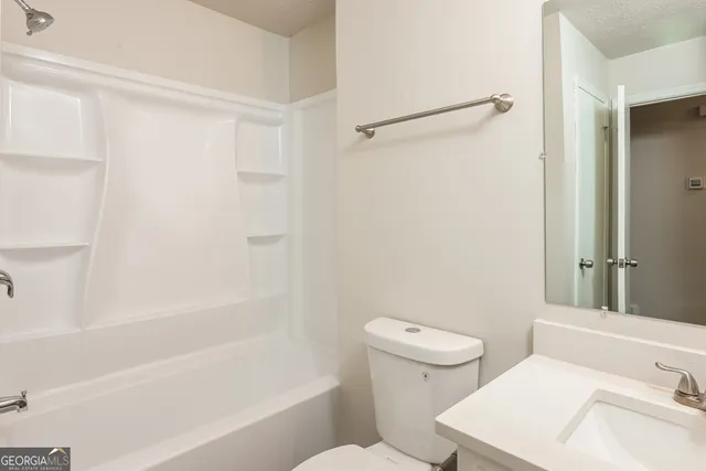 a bathroom with a sink a toilet and a bathtub