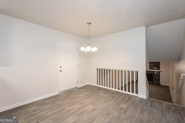 a view of a livingroom with wooden floor and stairs