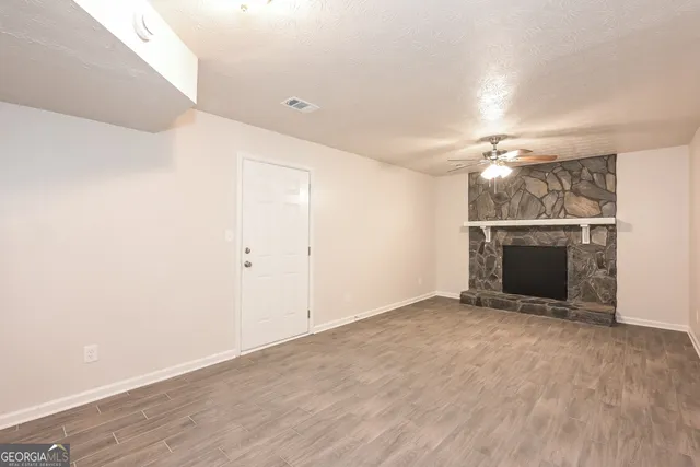 wooden floor in an empty room with a fireplace