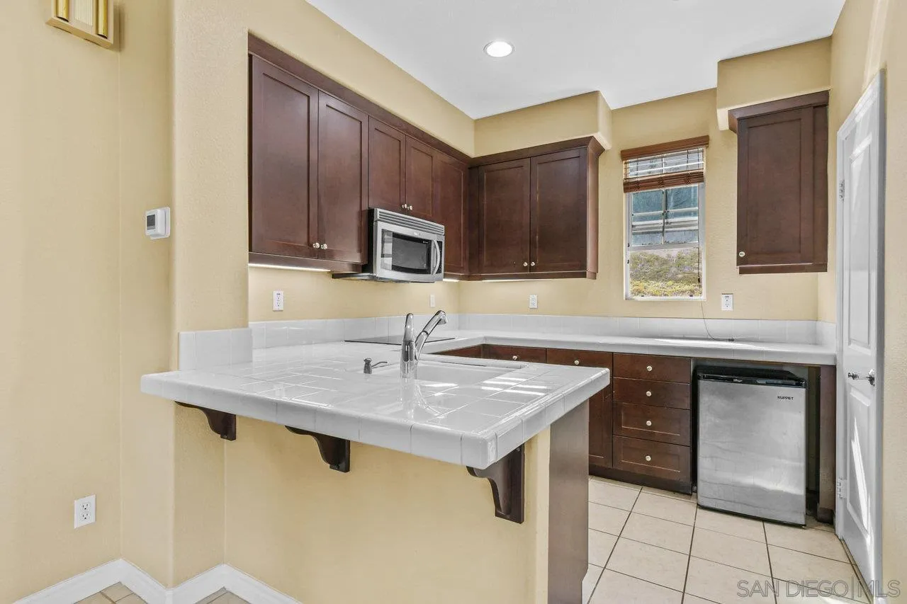 2957 Ranch Gate Road Chula Vista, CA 91914 - Photo 55 of 75 a kitchen with stainless steel appliances granite countertop a sink stove and refrigerator