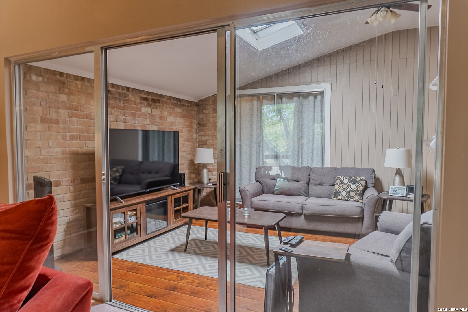 8942 Willmon Way Windcrest, TX 78239 - Photo 12 of 44 a living room with furniture a flat screen tv and a window