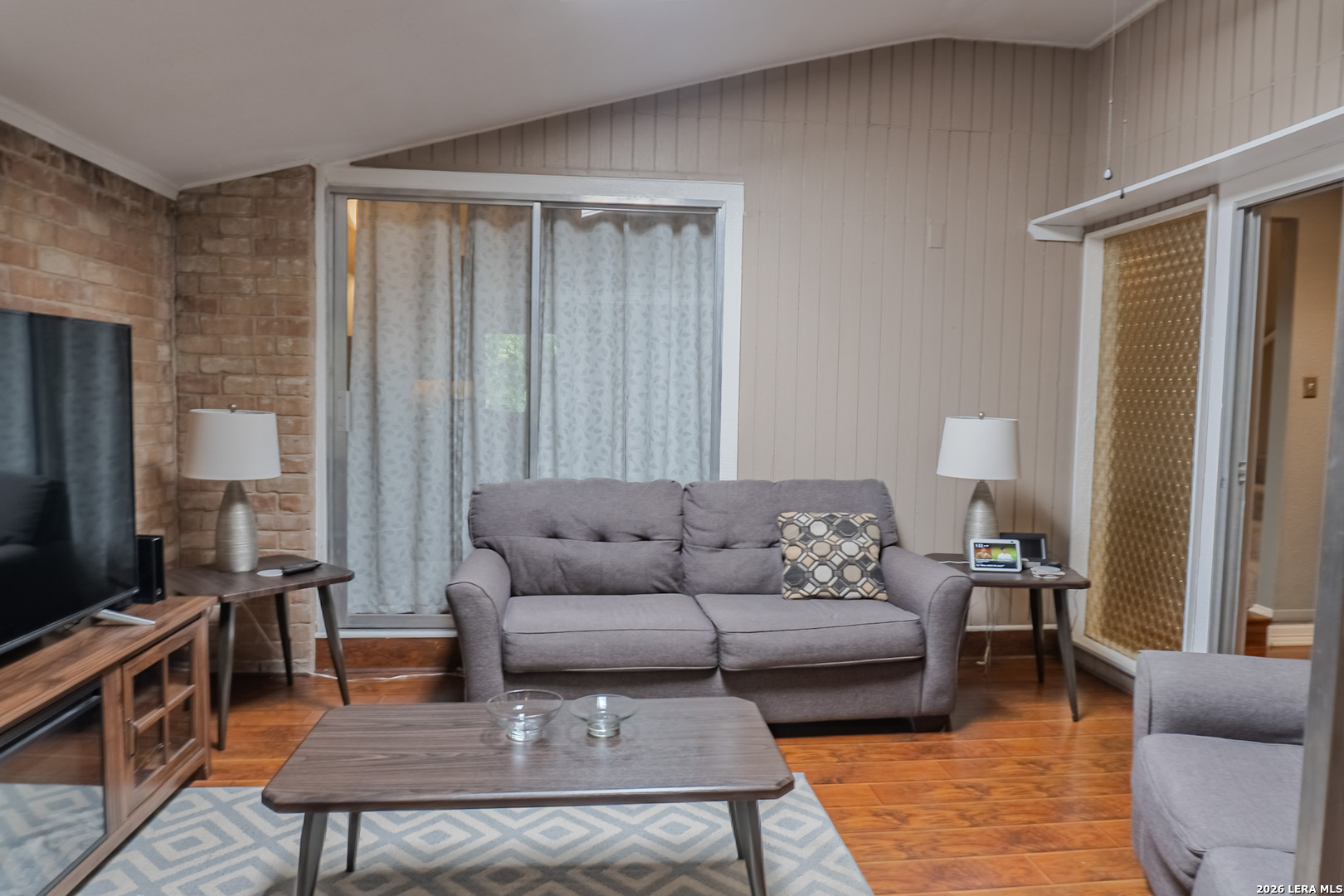8942 Willmon Way Windcrest, TX 78239 - Photo 14 of 44 a living room with furniture and a flat screen tv