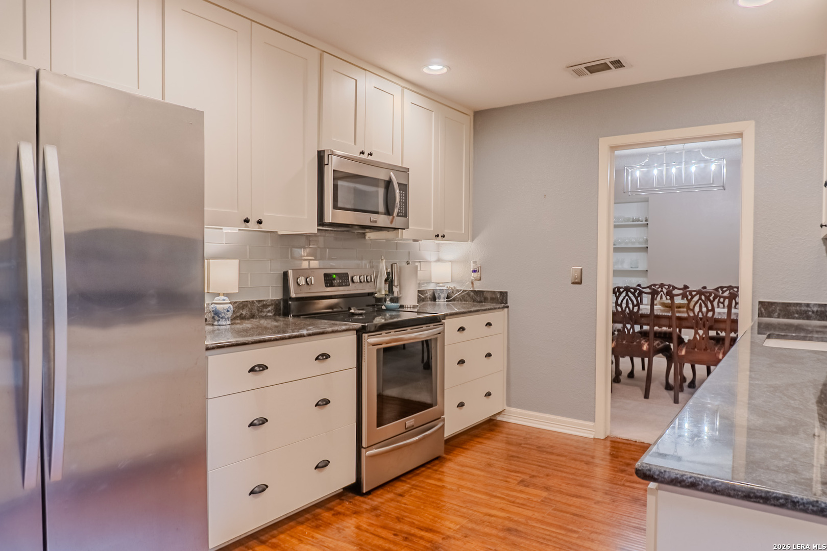 8942 Willmon Way Windcrest, TX 78239 - Photo 25 of 44 a kitchen with stainless steel appliances granite countertop a refrigerator a stove and a sink