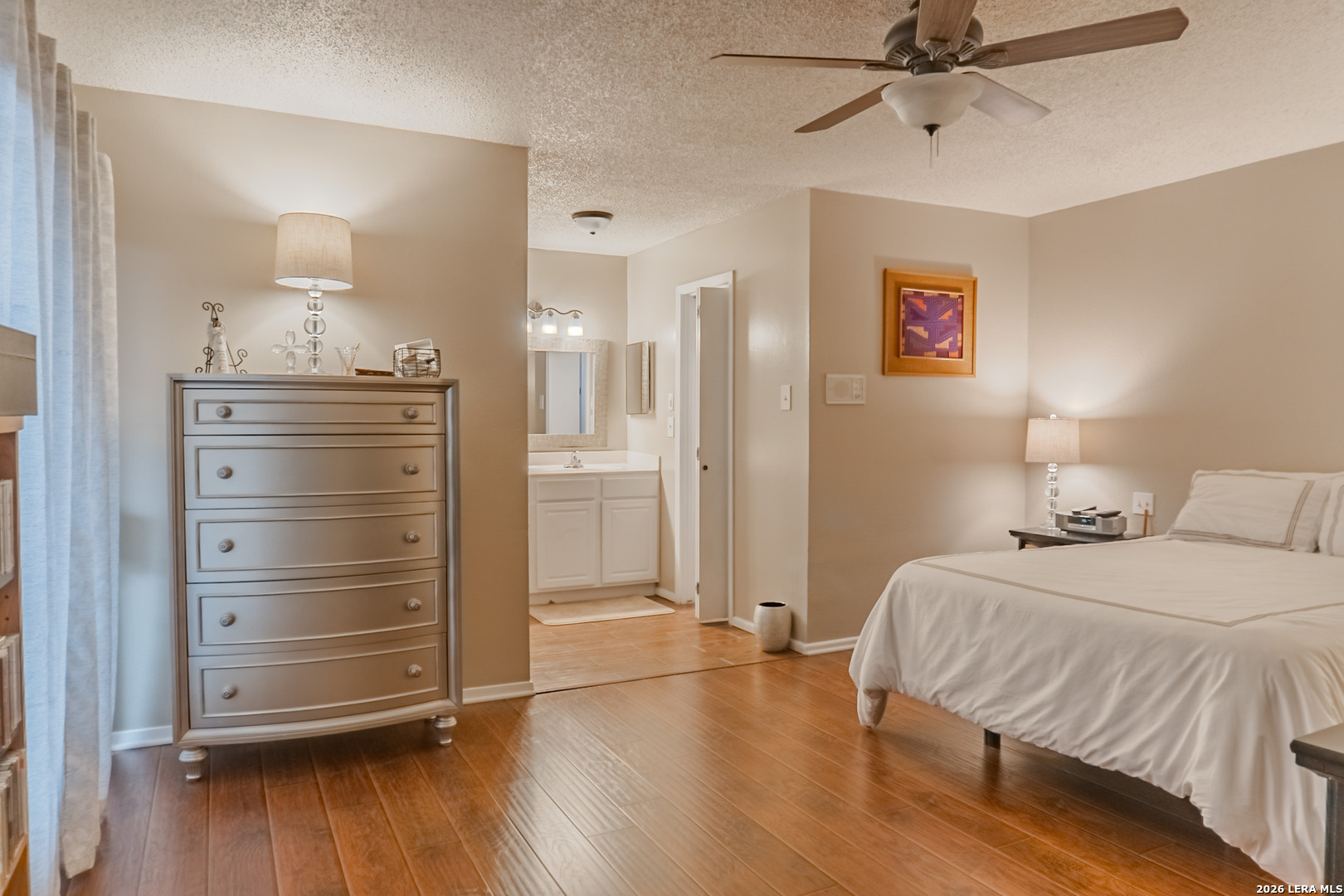 8942 Willmon Way Windcrest, TX 78239 - Photo 27 of 44 a bedroom with a bed and wooden floor