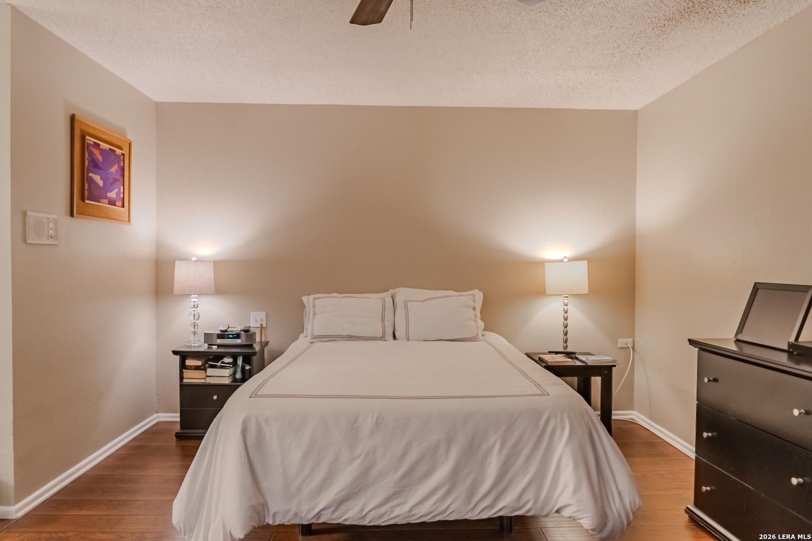 8942 Willmon Way Windcrest, TX 78239 - Photo 28 of 44 a bedroom with a bed and a night stand