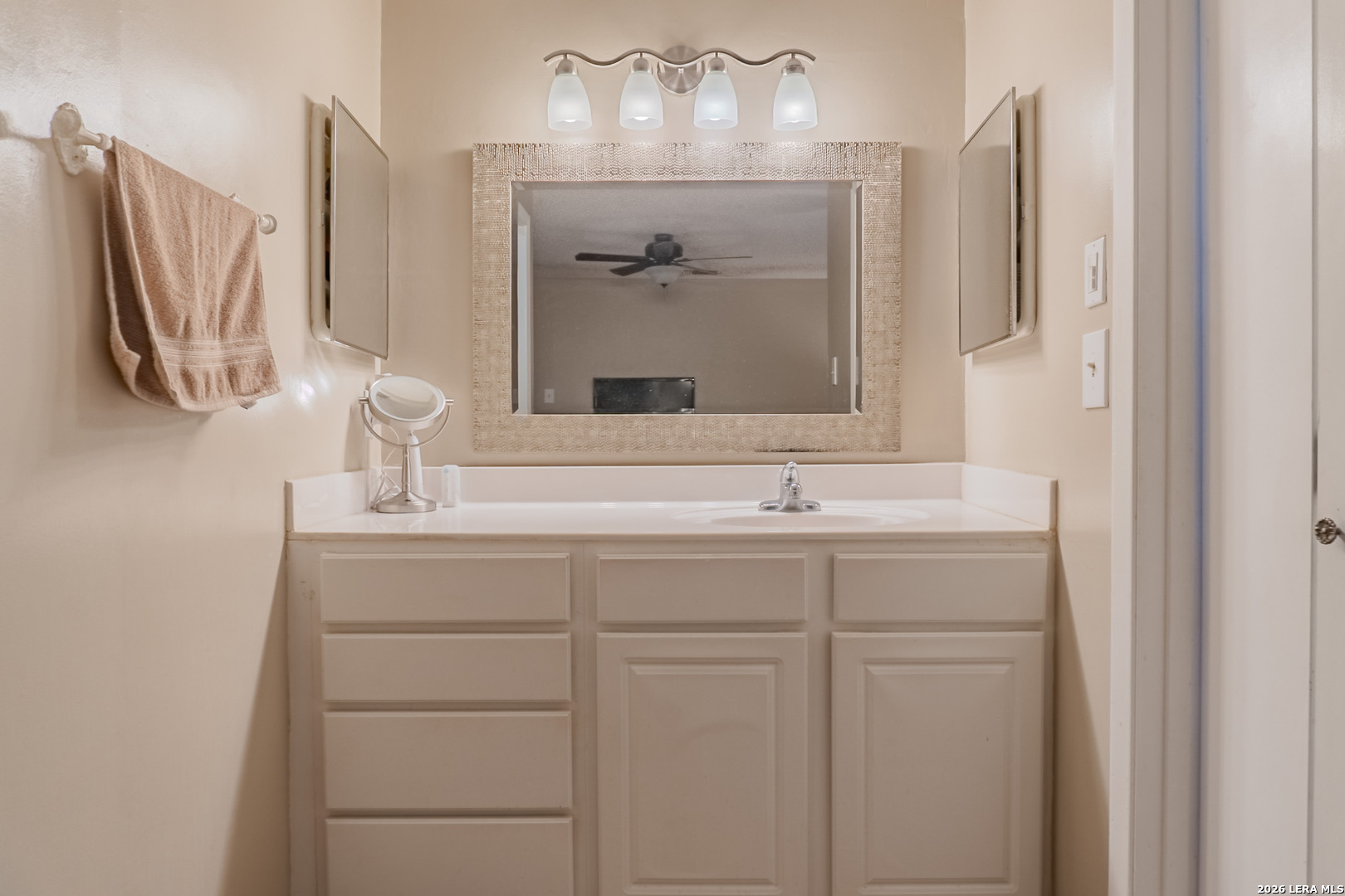 8942 Willmon Way Windcrest, TX 78239 - Photo 30 of 44 a bathroom with a sink and a mirror